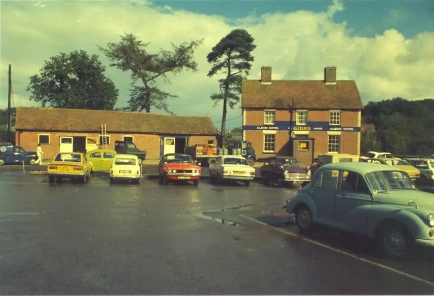 The Albion Hotel in the 1970s, with a navy Gibbs sign band and cars of the period in the car park