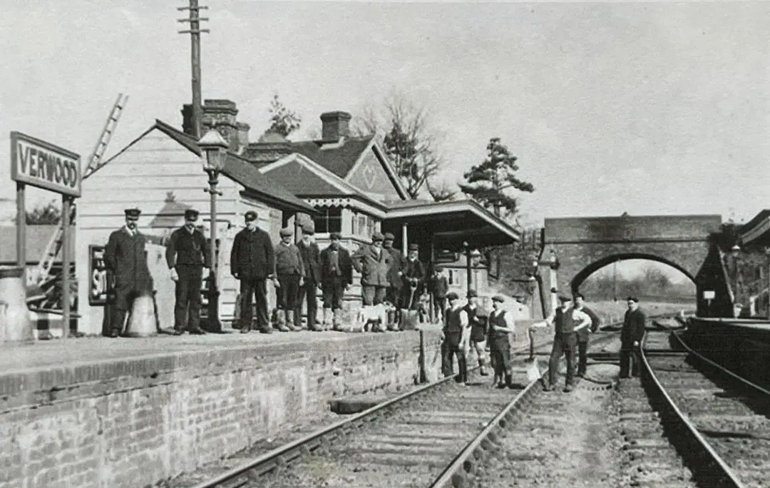 Staff and platelayers at Verwood station in 1910, with the brick road bridge behind them