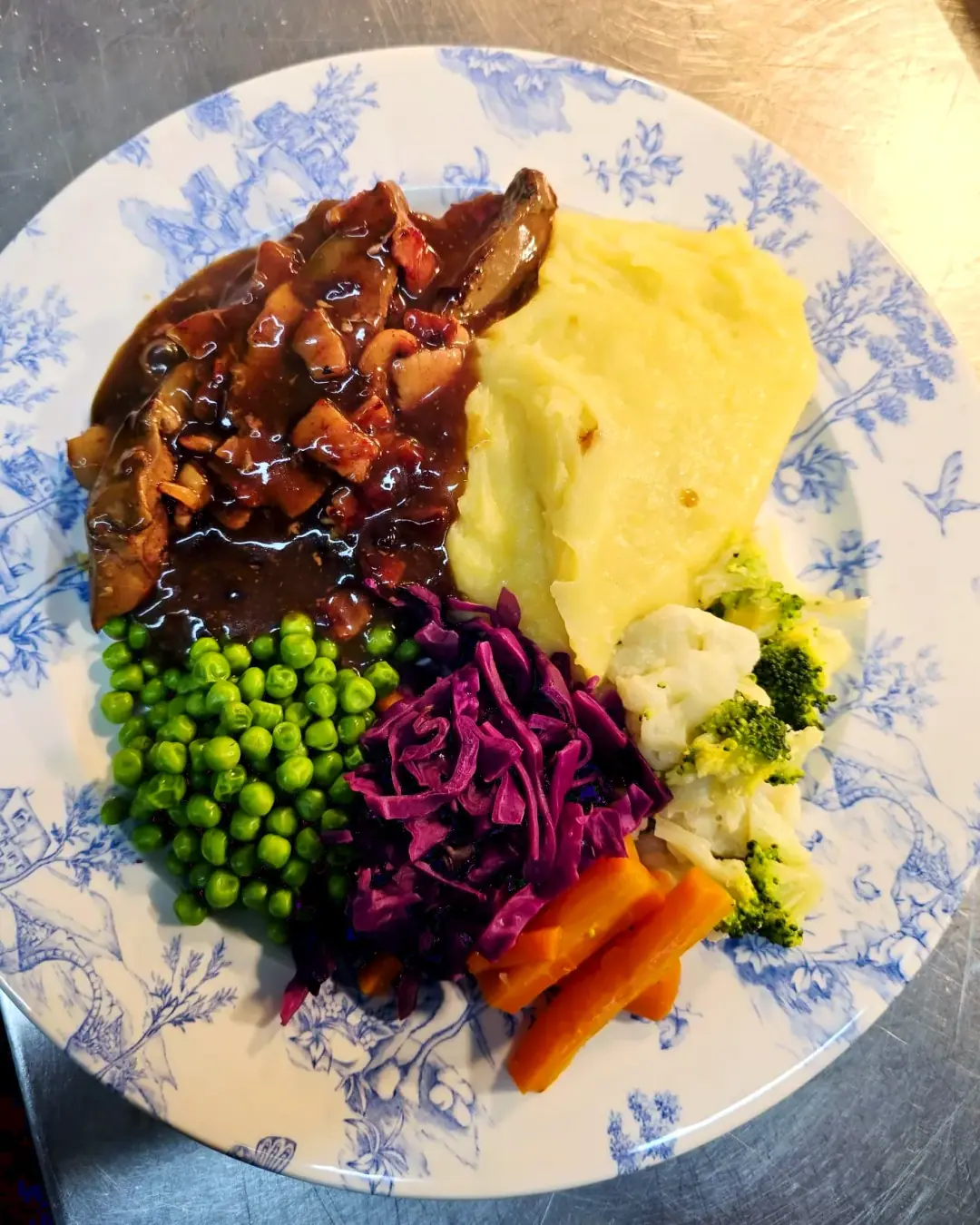 Liver and bacon with mash, red cabbage and vegetables