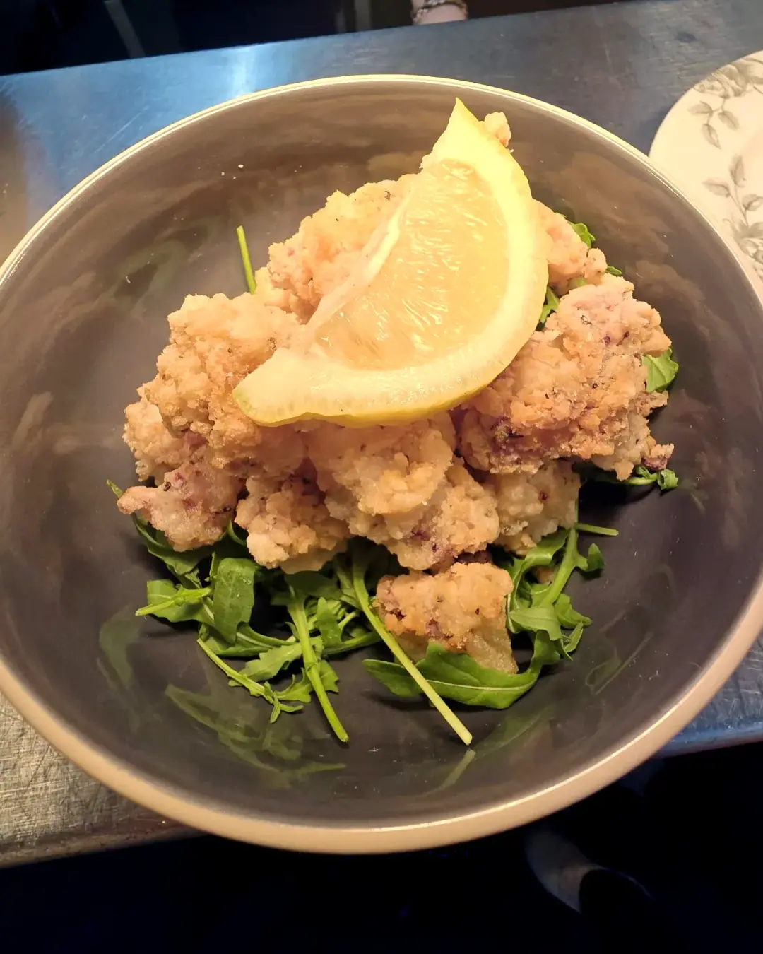 Salt and pepper squid with lemon and rocket